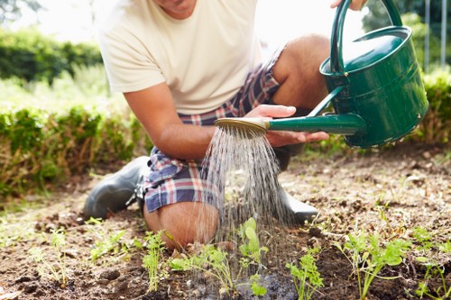 Front view of a gardener inspecting a Dulwich garden